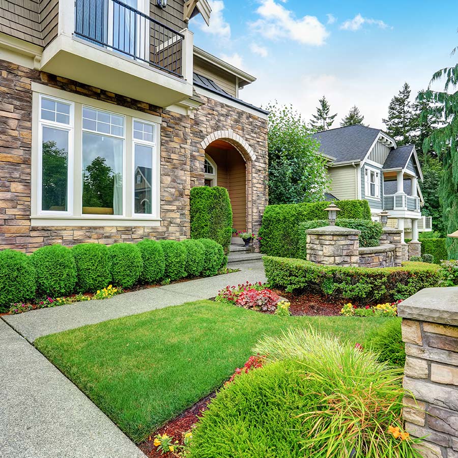 Well maintained landscaping in front yard of new home | Next Level Outdoor Services
