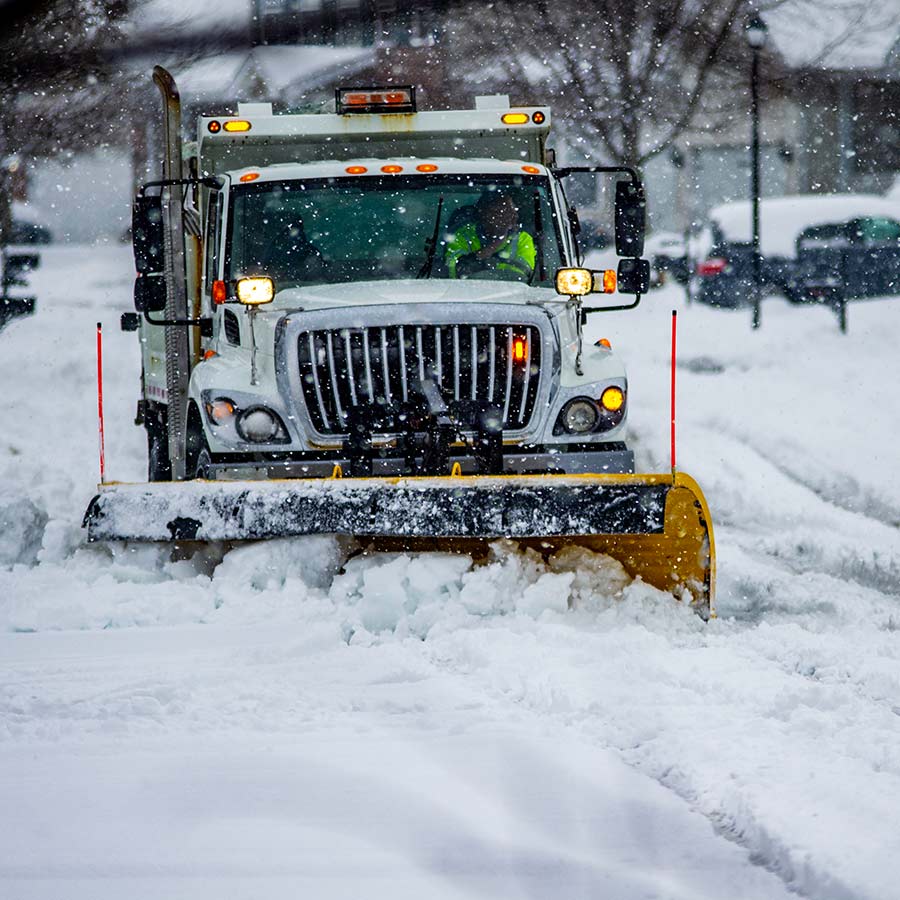 A Snowplow Clears a Long Driveway | Next Level Outdoor Services