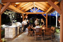 People grilling and socializing outdoors | Next Level Outdoor Services